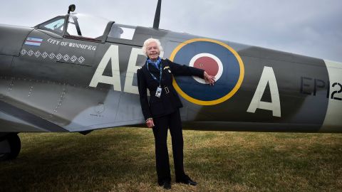 Battle of Britain veteran, pilot First Officer Mary Ellis, poses with a Spitfire aircraft at Biggin Hill airfield in Kent, on August 18, 2015. 