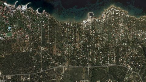 A satellite image of Mati taken in October last year shows how many houses were surrounded by flammable forest.