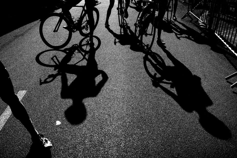 Riders' shadows are seen near the finish line after the 15th stage.