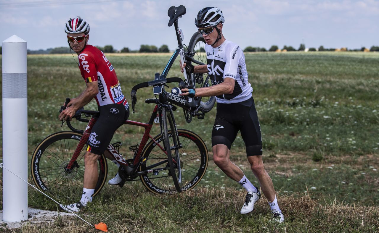 Belgium's Jasper De Buyst, left, and Britain's Chris Froome get back on the road after crashing during the first stage on July 7. Froome is the defending champion.