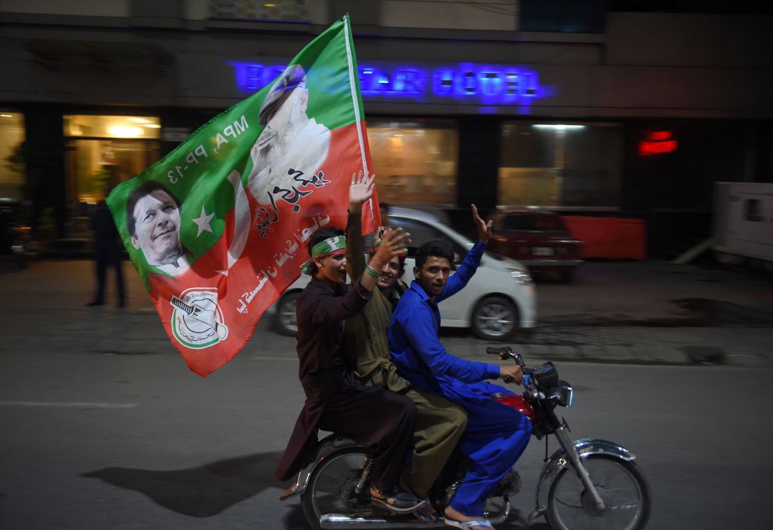 Supporters of Pakistan's cricketer-turned-politician Imran Khan celebrate in Rawalpindi on July 25, 2018.