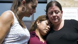 Yeni Gonzalez, a Guatemalan mother who was separated from her three children at the U.S.-Mexico border, center, is embraced by volunteer Janey Pearl, left, and Julie Schwietert Collazo during a news conference Tuesday, July 3, 2108 in New York. Gonzalez saw her children in a New York City facility for the first time since mid May.  She was driven cross-country by a team of volunteers after she was released from Eloy Detention Center in Arizona on Thursday. (AP Photo/Craig Ruttle)