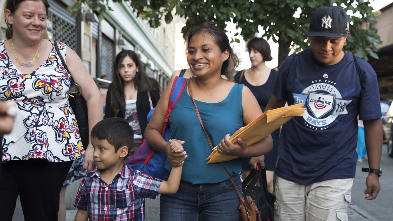 Julie Schwietert-Collazo, left, of Immigrant Families Together, walks with Rosayra Pablo Cruz, center, as she leaves the Cayuga Center with her sons 5-year-old Fernando, second from left, and 15-year-old Jordy on July 13 in New York.