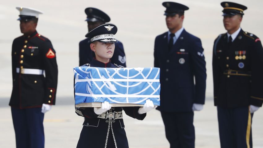 A soldier carries a casket containing the remains of a US soldier killed during the 1950-53 Korean War, after arriving from North Korea at Osan Air Base in Pyeongtaek on July 27, 2018. - A US military aircraft carrying the remains of US Korean War dead collected in North Korea arrived in the South on July 27, the 65th anniversary of the armistice that ended the fighting. (Photo by KIM HONG-JI / POOL / AFP)        (Photo credit should read KIM HONG-JI/AFP/Getty Images)