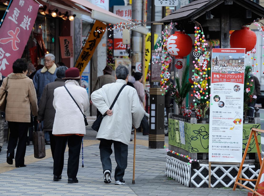 Elderly people walk in the street at Kouganji Temple in Tokyo. 