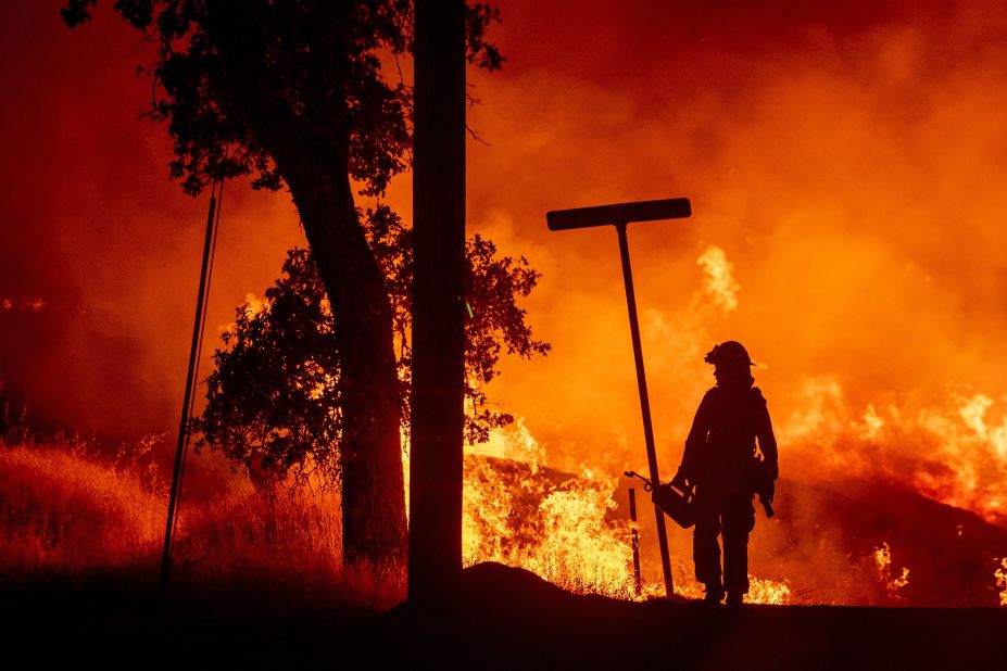 A firefighter lights backfires in Redding on July 27.