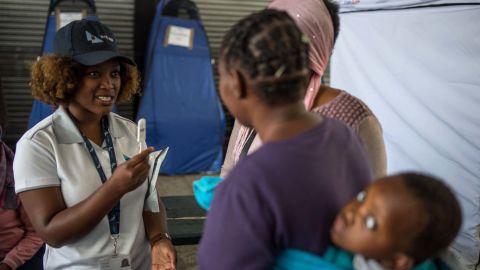 Students from the University of the Witwatersrand explain the self HIV testing kit, in Hillbrow, Johannesburg.