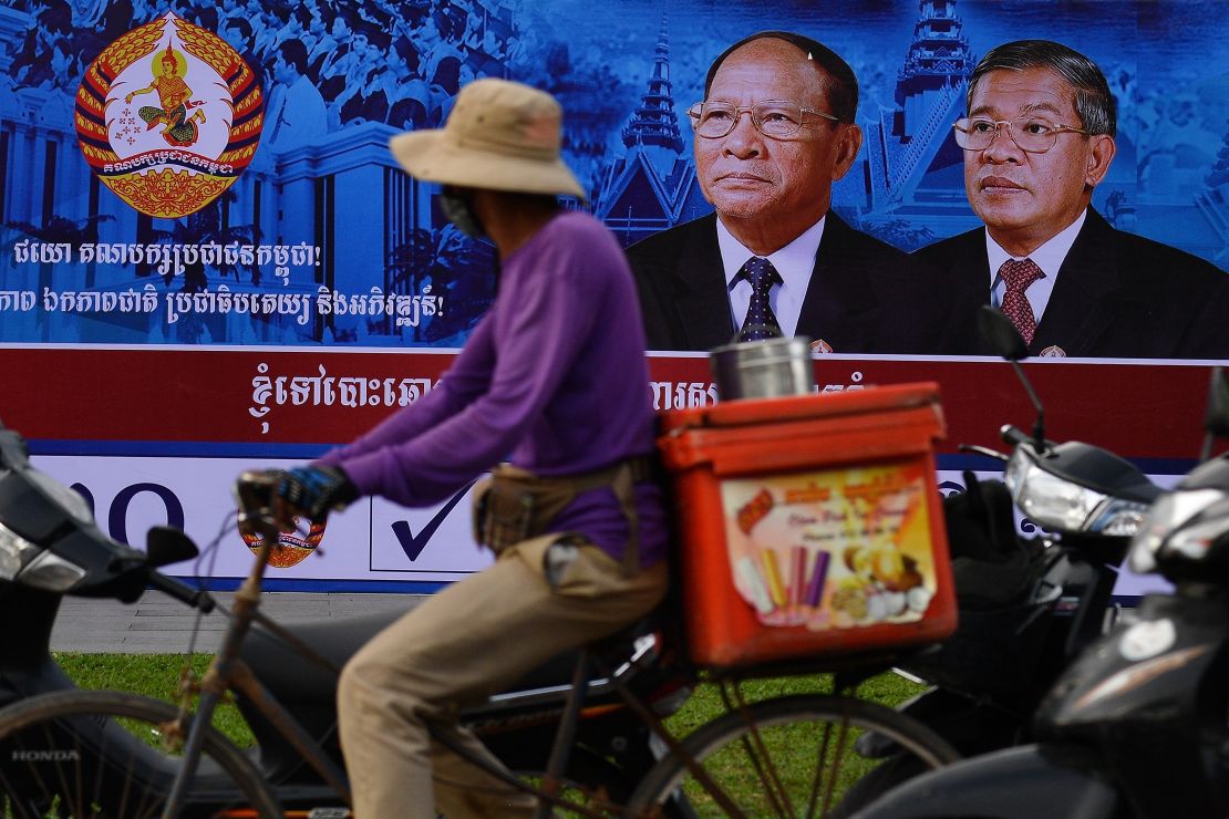 A cyclist rides past an electoral hoarding of Cambodia's Prime Minister and leader of the ruling Cambodian People's Party (CPP) Hun Sen, in Phnom Penh on Thursday.