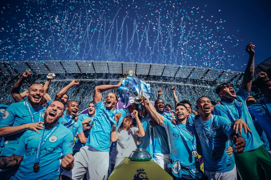 Vincent Kompany and Sergio Aguero of Manchester City lift the Premier League trophy following their win over Huddersfield Town at the Etihad Stadium.