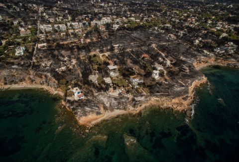 An aerial photo, taken on Thursday, July 26, shows damage that a wildfire caused in the Greek village of Mati. Authorities investigating the wildfire said that there are "serious indications of arson," but extreme weather conditions -- high temperatures, strong westerly winds and a dry winter -- contributed to the disaster.