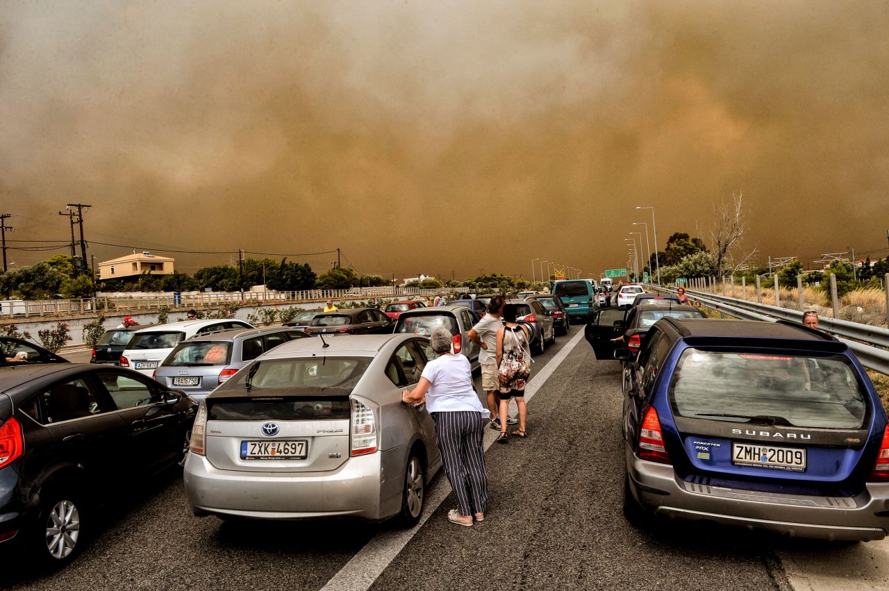 Cars are blocked after a wildfire caused a road closure in Kineta, Greece, on Monday, July 23.