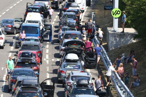 Traffic is backed up on the M20 motorway in England as people line up to get to the Eurotunnel in Folkestone, England, on Thursday, July 26. Passengers using the cross-Channel services were warned of delays of up to five hours after air-conditioning units failed on trains amid sizzling temperatures.