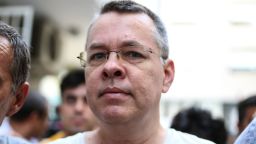 US pastor Andrew Craig Brunson escorted by Turkish plain clothes police officers arrives at his house on July 25, 2018 in Izmir. - Turkey on July 15, 2018 moved from jail to house arrest US pastor Andrew Brunson who has spent almost two years imprisoned on terror-related charges, in a controversial case that has ratcheted up tensions with the United States. Andrew Brunson, who ran a protestant church in the Aegean city of Izmir, was first detained in October 2016 and had remained in prison in Turkey ever since. (Photo by - / AFP) 