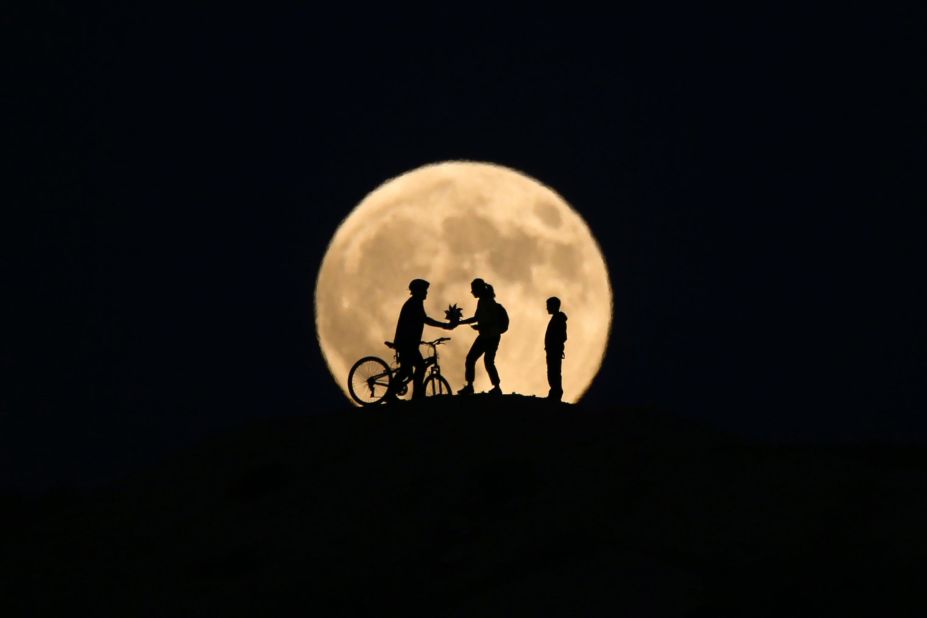 People's silhouettes can be seen in Van, Turkey, during the partial phase of the eclipse.