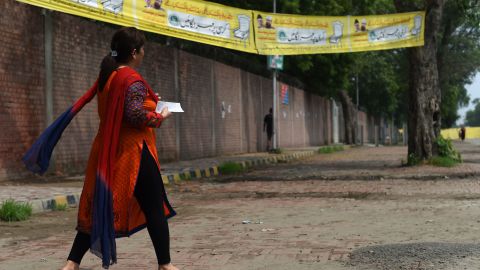 A Pakistani woman walks to cast her vote.