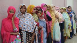 TOPSHOT - Pakistani women stand in a queue as they wait to cast their vote outside a polling station during general election in Lahore on July 25, 2018. - Pakistanis vote on July 25 in elections that could propel former World Cup cricketer Imran Khan to power, as security fears intensified with a voting-day blast that killed at least 30 after a campaign marred by claims of military interference. (Photo by ARIF ALI / AFP)        (Photo credit should read ARIF ALI/AFP/Getty Images)