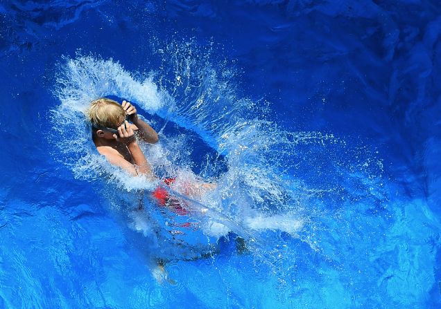 A boy jumps in the swimming pool on the premises of the coking plant of the Zollverein Coal Mine Industrial Complex on Sunday, July 22. 