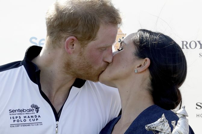 Meghan, Duchess of Sussex, and Britain's Prince Harry kiss during the presentation ceremony for the Sentebale ISPS Handa Polo Cup at the Royal County of Berkshire Polo Club in Windsor, England, on Thursday, July 26. 