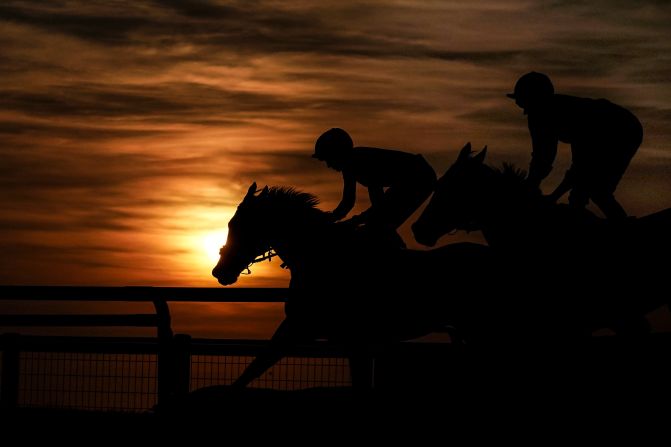 The sun sets on the final race of the evening at Sandown Park Racecourse on Wednesday, July 25, in Esher, United Kingdom. 