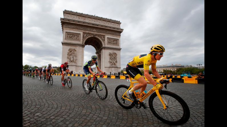 <a href="index.php?page=&url=https%3A%2F%2Fwww.cnn.com%2F2018%2F07%2F29%2Fsport%2Ftour-de-france-geraint-thomas-wins%2Findex.html" target="_blank">Tour de France winner Britain's Geraint Thomas</a>, wearing the overall leader's yellow jersey, passes the Arc de Triomphe during the twenty-first stage of the Tour de France in Paris, France, on Sunday July 29. 