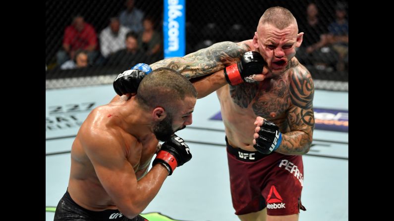 John Makdessi punches Ross Pearson in their lightweight bout during the UFC Fight Night event at Scotiabank Saddledome on Saturday, July 28, in Alberta, Canada. 