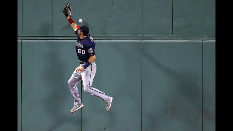 Minnesota Twins' Jake Cave cannot make the play on a two-run triple by the Boston Red Sox's Jackie Bradley Jr. during the fourth inning of a baseball game in Boston on Saturday, July 28. 
