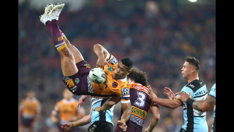 Jamayne Isaako of the Broncos is tackled in the air during the round 20 NRL match between the Brisbane Broncos and the Cronulla Sharks on Thursday, July 26, in Brisbane, Australia.  