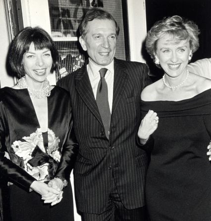 Wintour poses with the late columnist Nigel Dempster and fellow magazine editor Tina Brown at a Vogue party honoring Dempster in New York in November 1989.