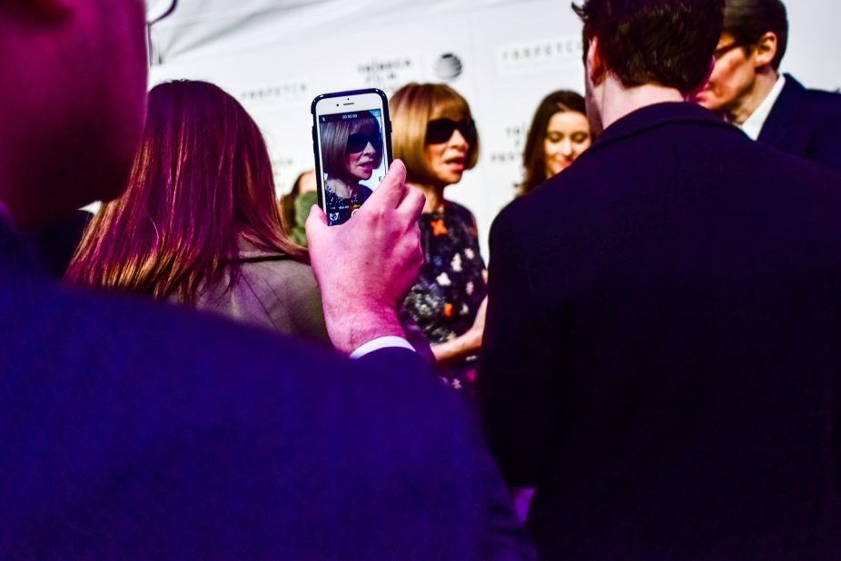 An attendee takes a photo of Anna Wintour on the red carpet for the "The First Monday in May" premiere at the Tribeca Film Festival in New York on April 13, 2016. The film is a documentary about the making of the "China: Through the Looking Glass" spring2015 exhibition and gala at the Met's Costume Institute. 