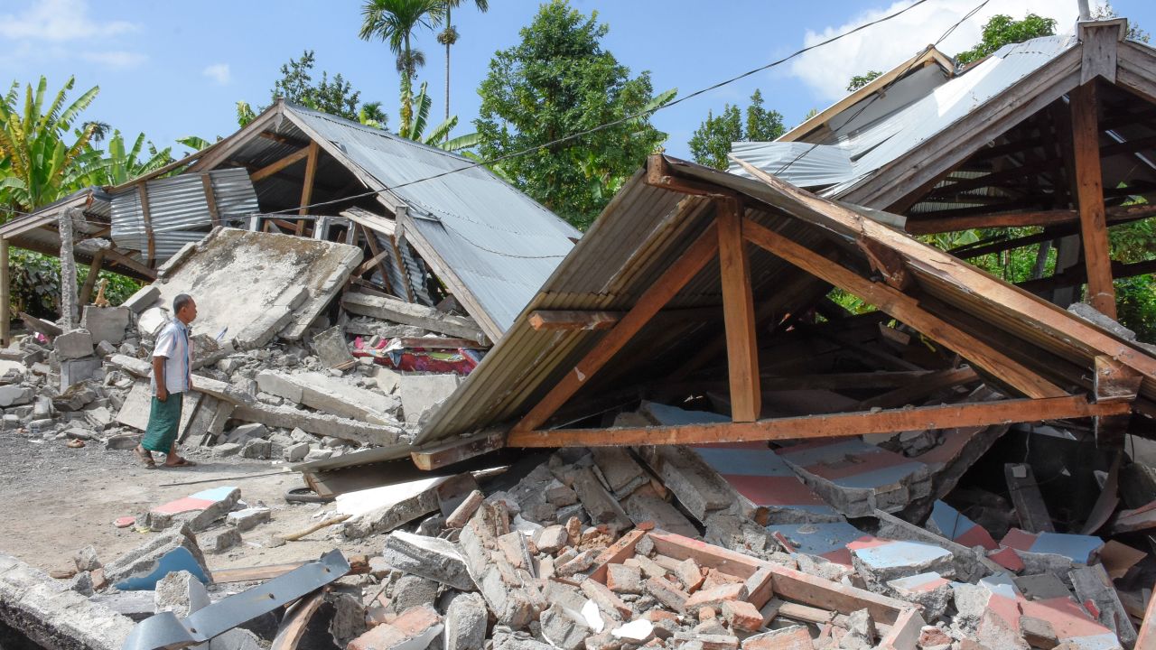 An Indonesian man examines the remains of houses, after a 6.4 magnitude earthquake struck, in Lombok on July 29.
