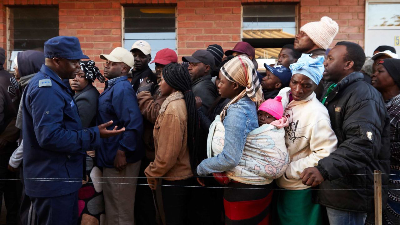 People queue to vote early Monday morning.