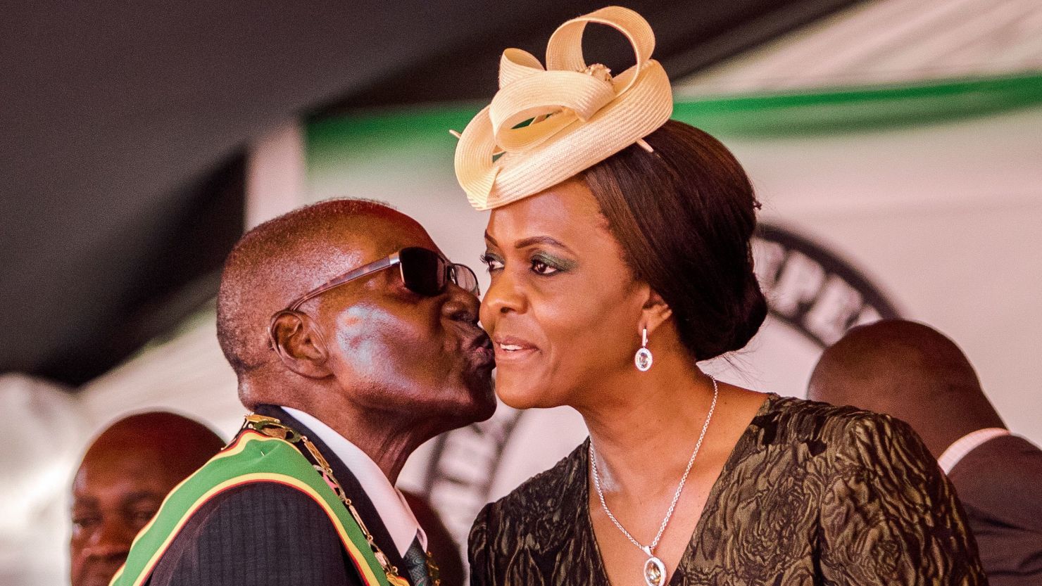 Former president Robert Mugabe kisses his wife and former first lady Grace Mugabe during during the country's 37th Independence Day celebrations at the National Sports Stadium in Harare April 18, 2017. 