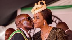President Robert Mugabe kisses his wife and first lady Grace Mugabe during during the country's 37th Independence Day celebrations at the National Sports Stadium in Harare April 18, 2017. / AFP PHOTO / Jekesai NJIKIZANA        (Photo credit should read JEKESAI NJIKIZANA/AFP/Getty Images)