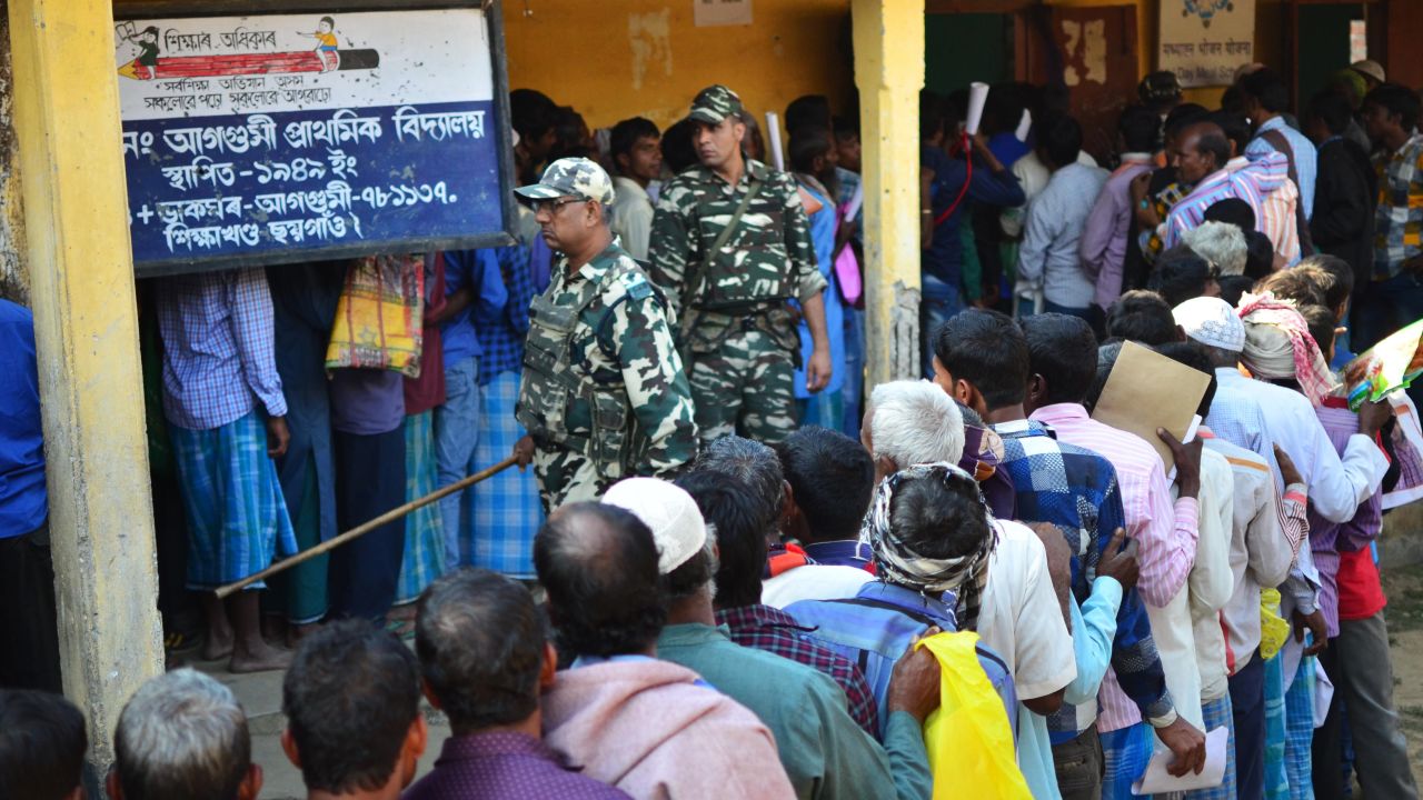 People stand in line to check their names on the first draft of the National Register of Citizens (NRC) at Gumi village of Kamrup district in the Indian state of Assam on January 1, 2018. 
