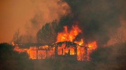 A house burns at the Mendocino Complex fire near Finley, California on July 30, 2018. Thousands of firefighters in California made some progress against several large-scale blazes that have turned close to 200,000 acres into an ashen wasteland, destroyed expensive homes, and killed eight fire personnel and civilians in the most populous US state. The worst blaze, northern California's Carr Fire, has killed six people since Thursday, including a 70-year-old woman and her two great-grandchildren aged four and five. They perished when flames swallowed their home in Redding. / AFP PHOTO / JOSH EDELSONJOSH EDELSON/AFP/Getty Images