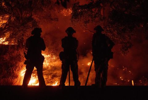 Firefighters in Upper Lake watch a back burn on July 31.