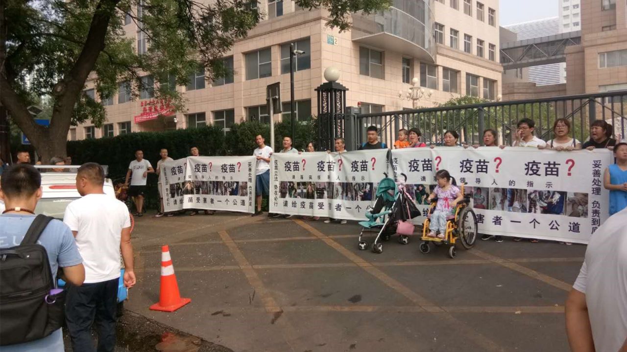 Small group of protestors hold a rare public demonstration over the vaccine scandal in front of China's National Health Commission in Beijing on Monday July 30.