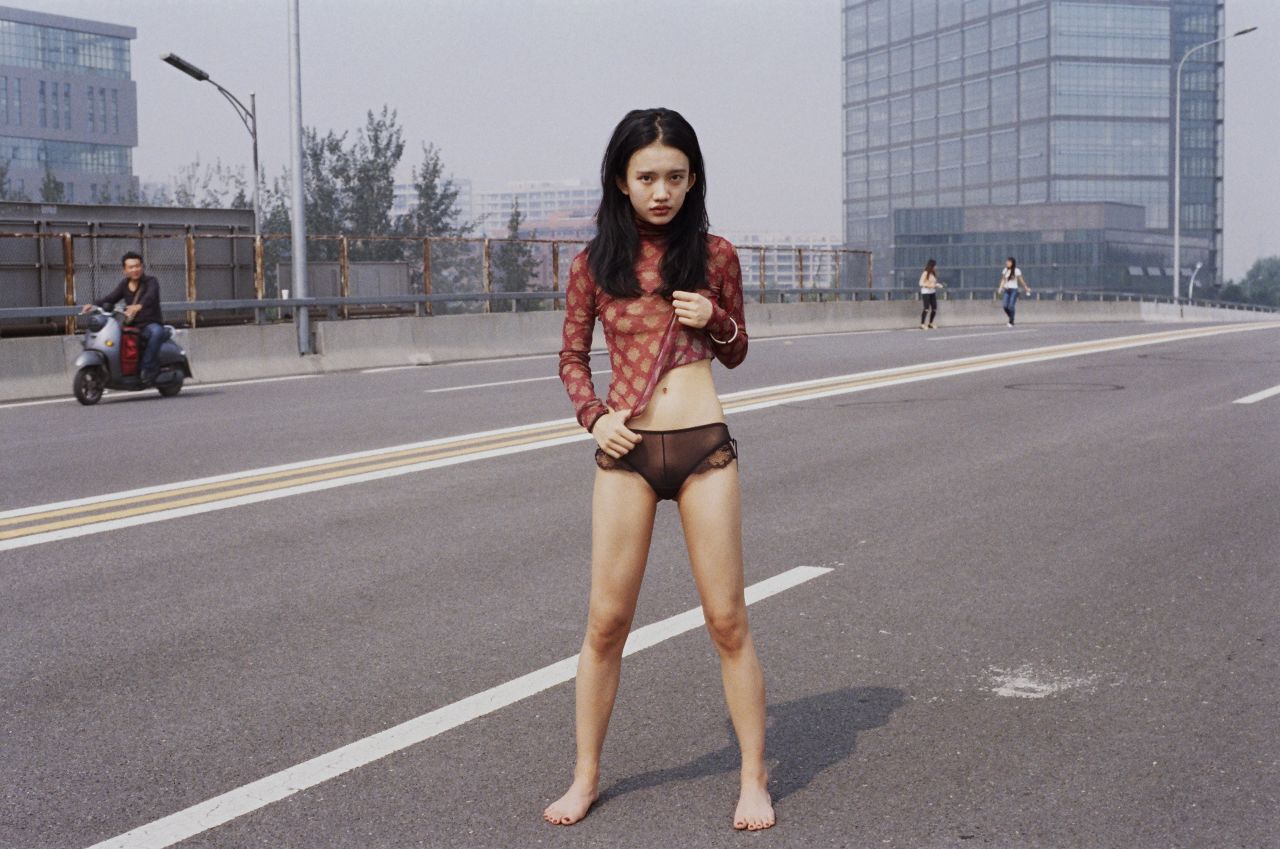 Many of Luo's portraits are shot against urban backdrops.