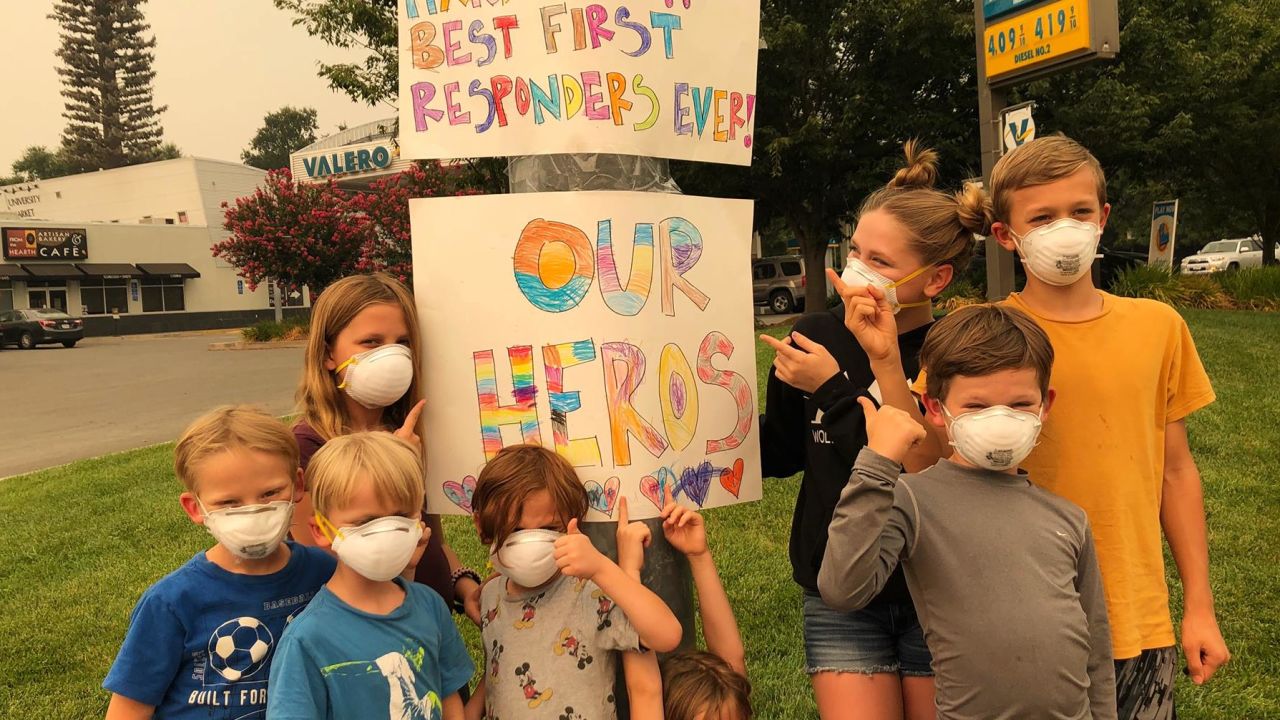 Nichole Grubbs-Miller and her sister's children made signs thanking firefighters for their service fighting the Carr Fire. 