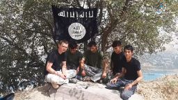 A still from the video found on ISIS telegram channels, showing five men sitting under the ISIS flag on a rocky hill pledging allegiance to Abu Bakr Al-Boghdadi. They are introduced as the perpetrators of the attack in Western Tajikistan without giving details about the attack itself.