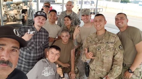 A selfie of Borjon and Buchan with members of the National Guard in Redding.