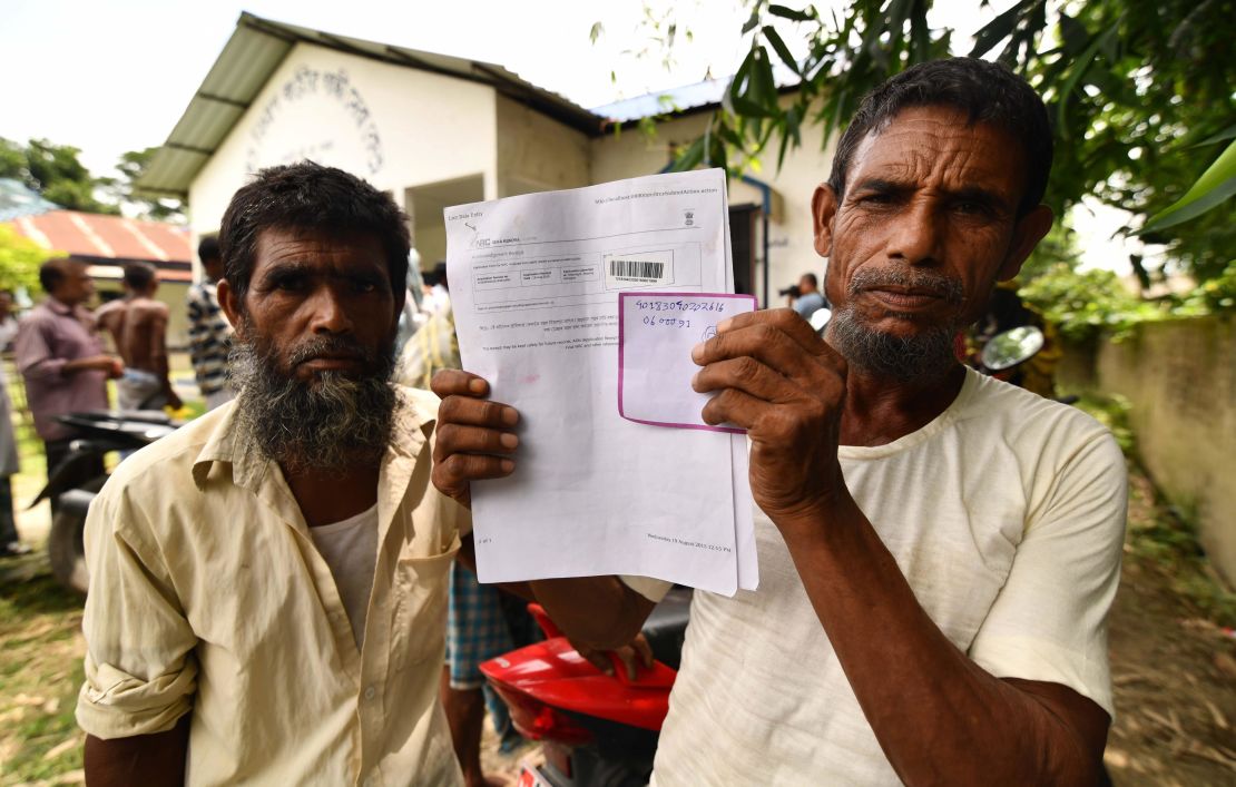A resident holds documents on his way to check his name on the final list of National Register of Citizens (NRC) in Kuranibori village, in Assam's Morigoan district on July 30, 2018.