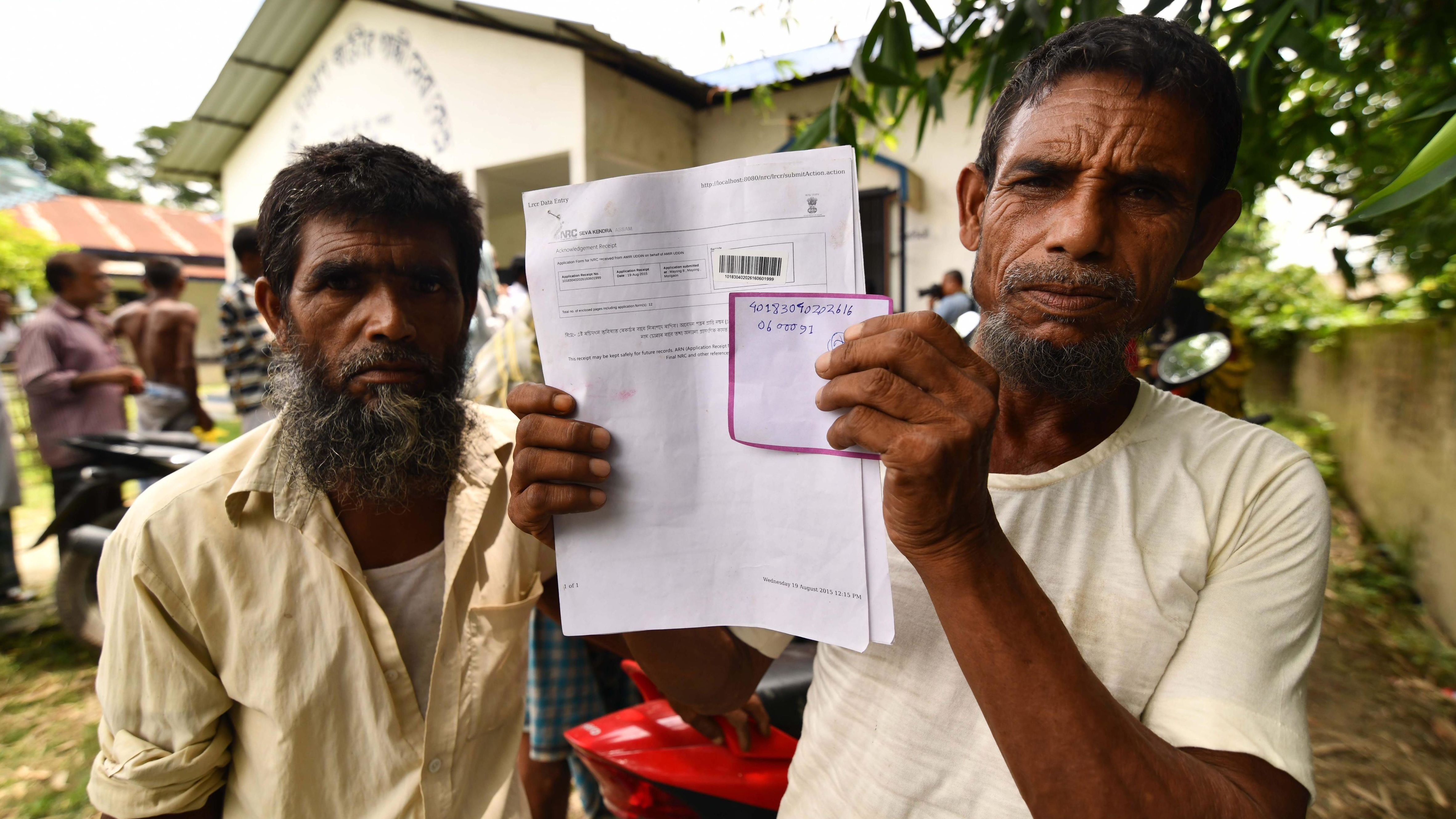 A resident holds documents on his way to check his name on the final list of National Register of Citizens (NRC) in Kuranibori village, in Assam's Morigoan district on July 30, 2018.