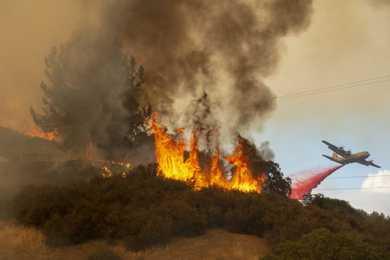 Fire retardant is dropped near a home as the Mendocino Complex Fire burns near Lakeport on Monday, July 30.