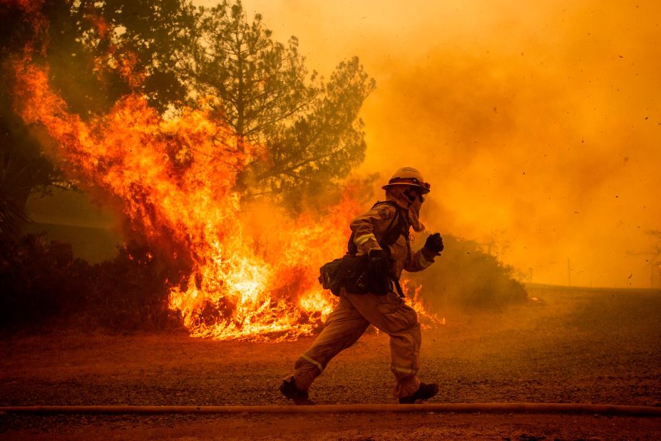 A firefighter runs while trying to save a house in Lakeport.