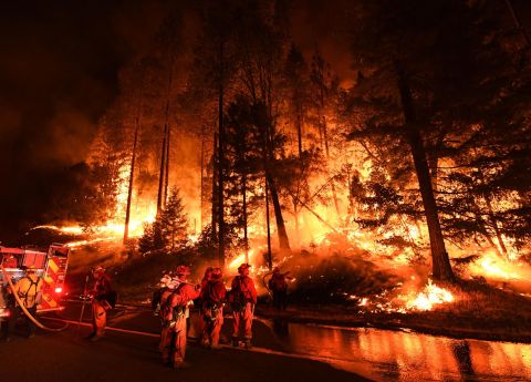 Firefighters try to control a back burn as the Carr Fire spreads toward the towns of Douglas City and Lewiston on July 31.