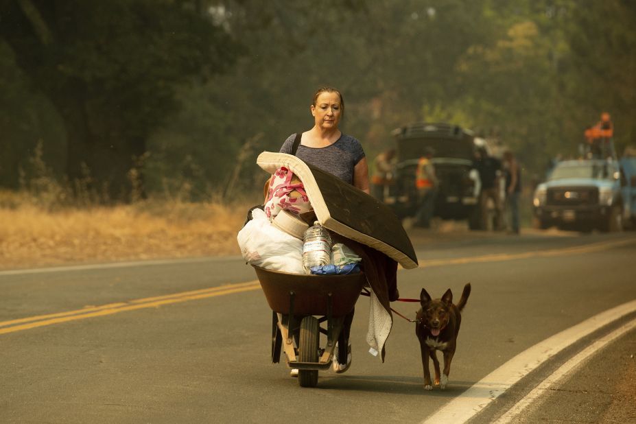 A woman leaves Lakeport as the River Fire approaches on July 31. 