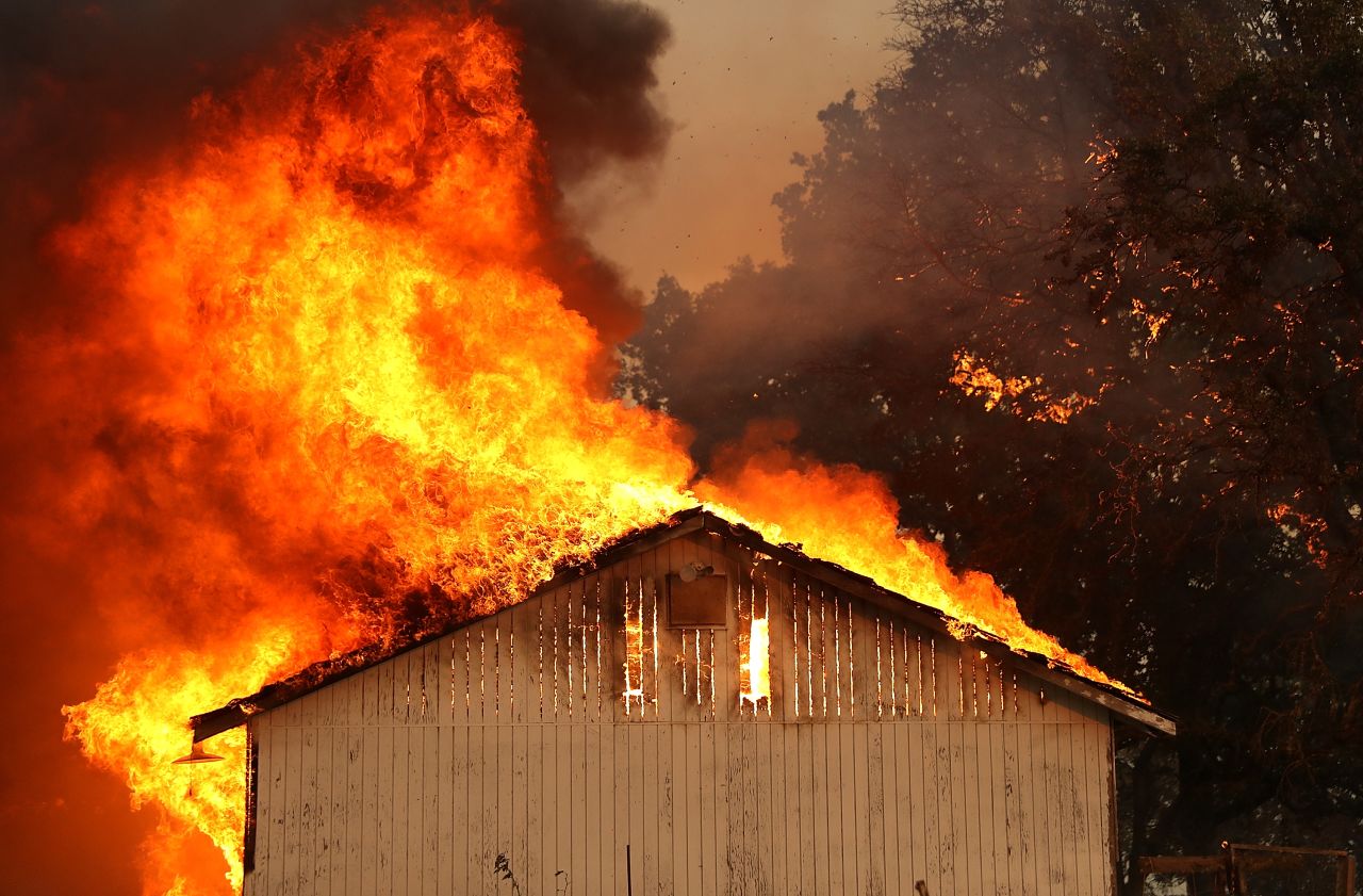 A house burns as the River Fire moves through the Lakeport area on July 31.