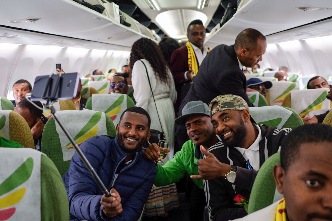 Passengers pose for a selfie inside an Ethiopian Airlines flight from Addis Ababa, Ethiopia, to Eritrea's capital Asmara on July 18. It was the first commercial flight from Ethiopia to Eritrea in two decades.