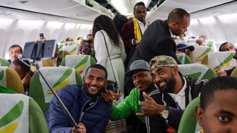 Passengers pose for a selfie inside an Ethiopian Airlines flight from Addis Ababa, Ethiopia, to Eritrea's capital Asmara on July 18. It was the first commercial flight from Ethiopia to Eritrea in two decades.